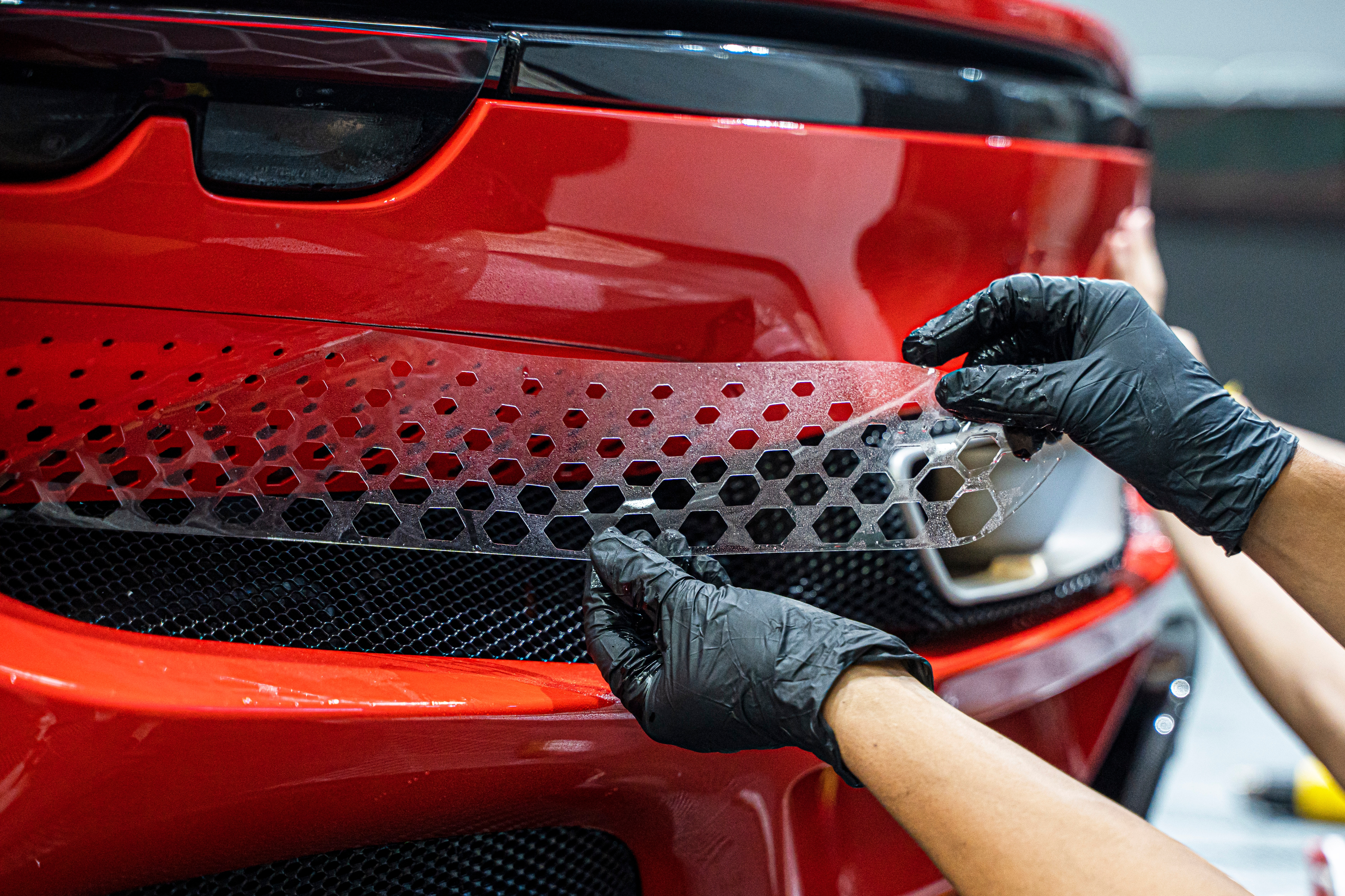 Paint Protection Film installation on a red sports car